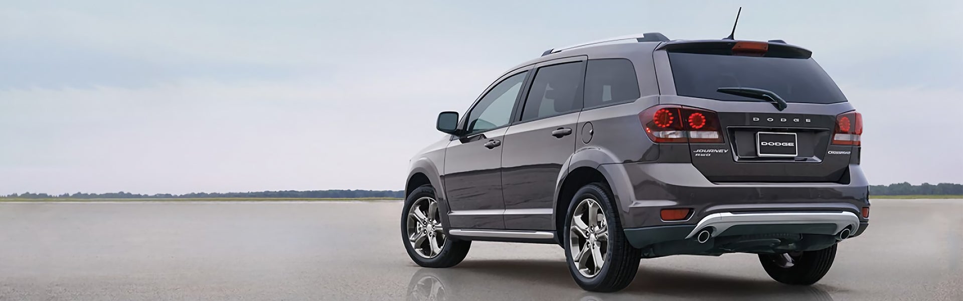 A Dodge Journey parking on wet road