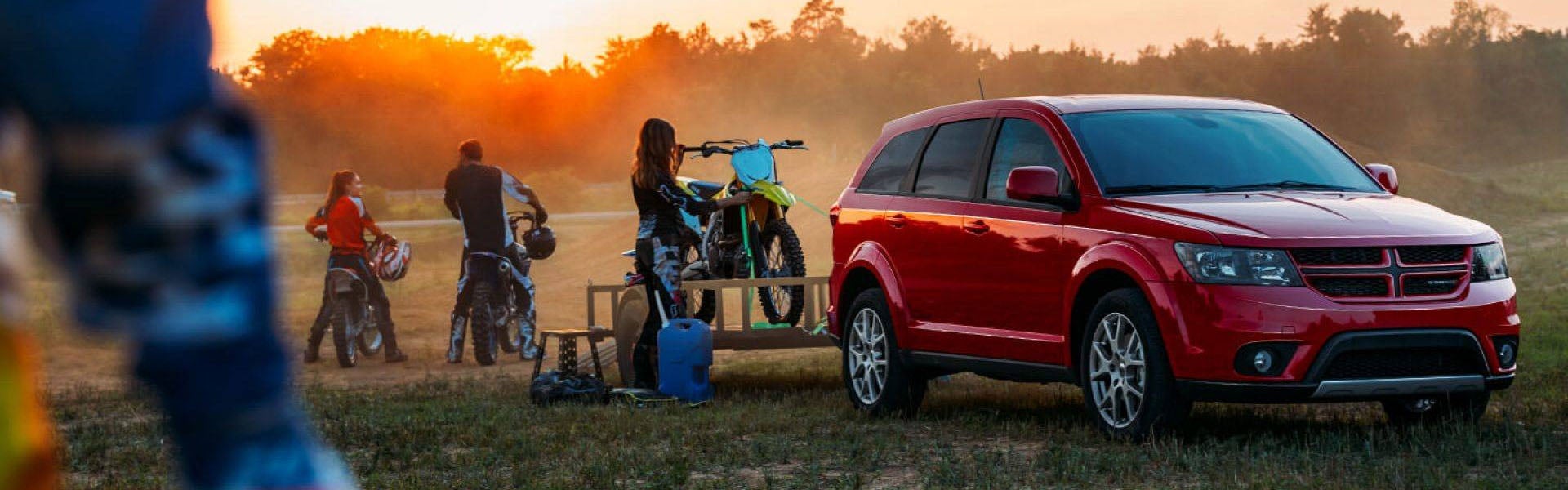 Family dirt bike outing and unloading bike from their Dodge SUV