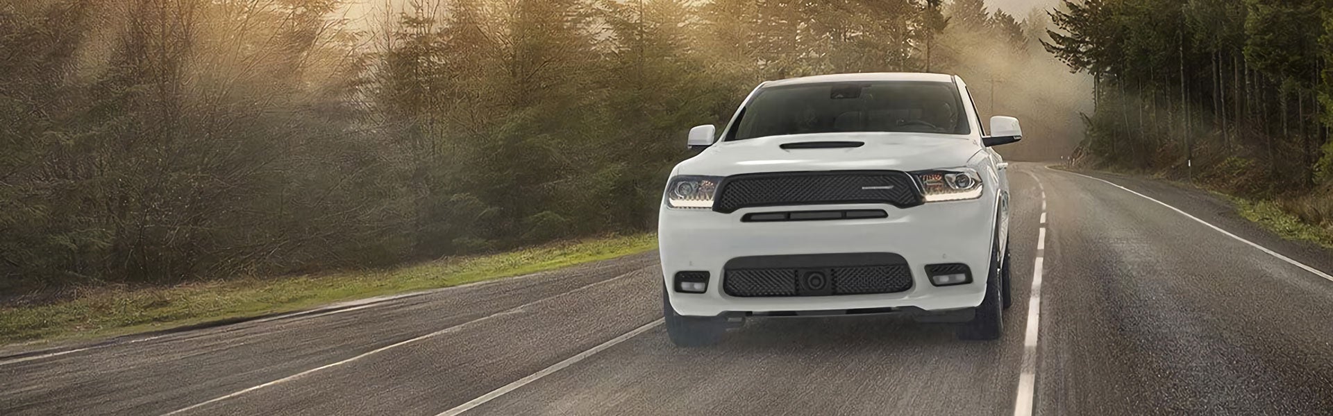 White Dodge Durango driving at high speed down the road
