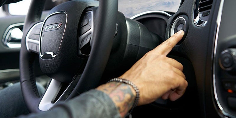 Man using his finger to push to start a brand new Dodge Durango