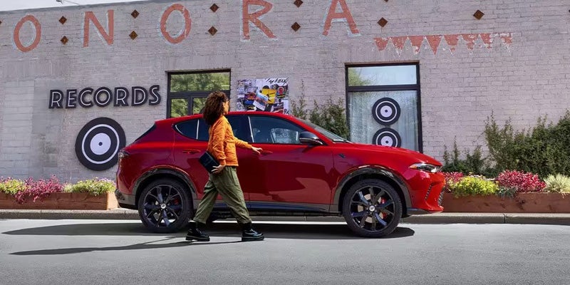 Dan Cummins Chrysler Dodge Jeep Ram Georgetown in Georgetown KY customer opening door to a used Dodge Hornet 