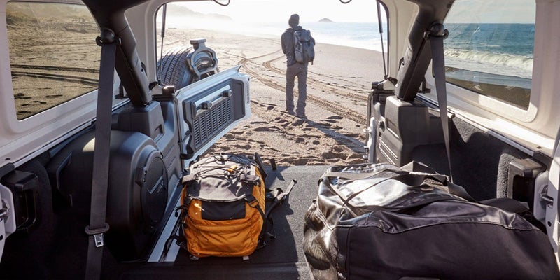 Jeep Wrangler parked on the beach with a ton supplies in the vehicle
