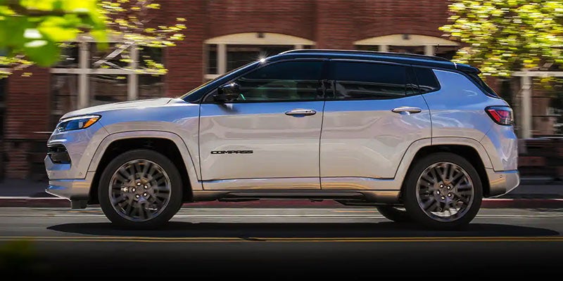 White Jeep Compass going down the street at high speed