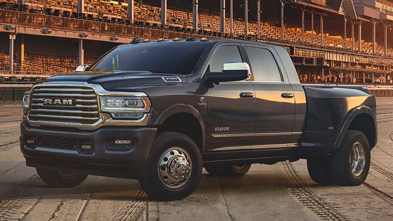 Black Ram 3500 parked next to a construction site while the sun is setting