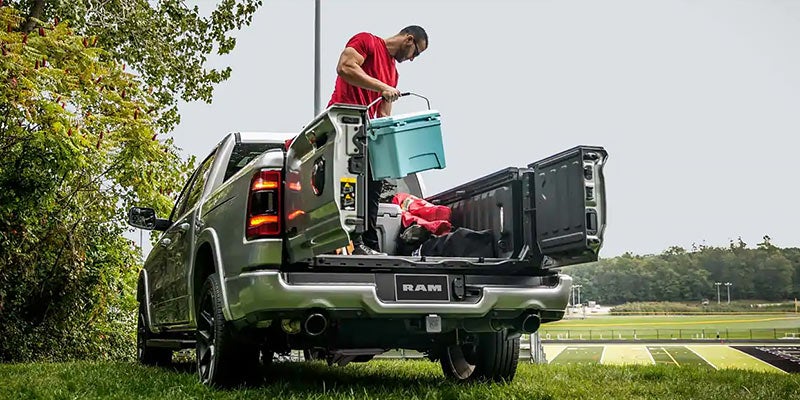 Man in red tshirt unloading his items from the back of a Ram 1500
