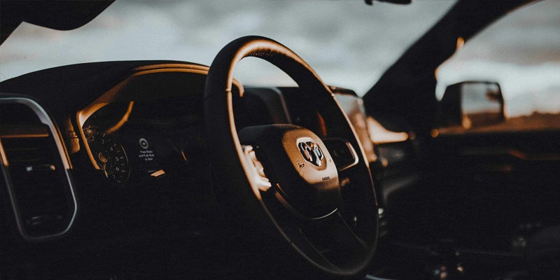 sun setting on the steering wheel of a Ram 1500