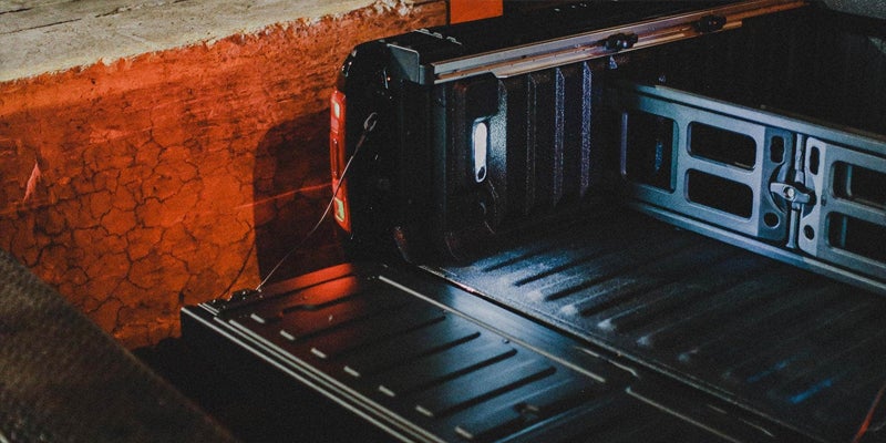 Black Ram 1500 opening its hatch to load supplies on the truck bed