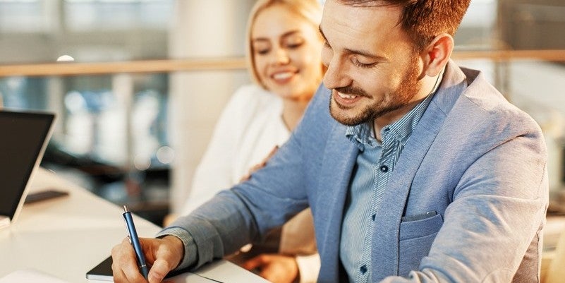 couple customer signing finance form