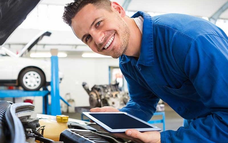 Service inspector inspecting car parts