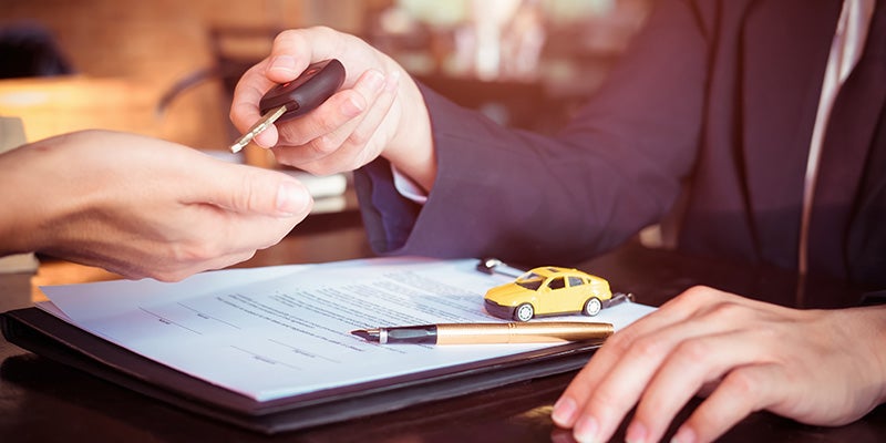 Dan Cummins Chrysler Dodge Jeep Ram Georgetown in Georgetown KY customer finishing paperwork for new Dodge Ram 2500