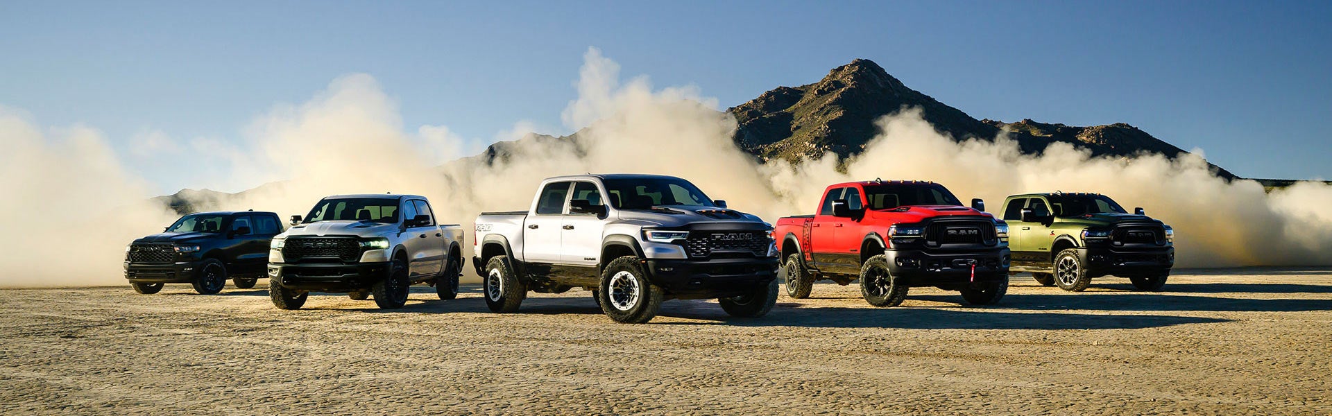 Row of pickup trucks line up in desert