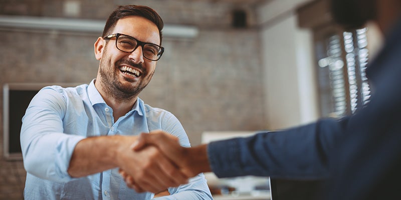 Dan Cummins Chrysler Dodge Jeep Ram Georgetown in Georgetown KY customer shaking hands with a sales rep