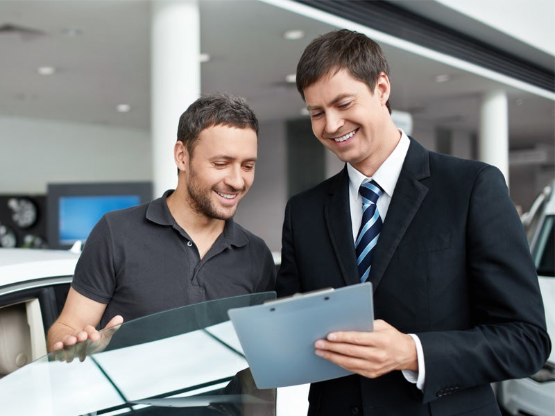 Dan Cummins Chrysler Dodge Jeep Ram Georgetown in Georgetown KY customer finishing paperwork for new used Dodge