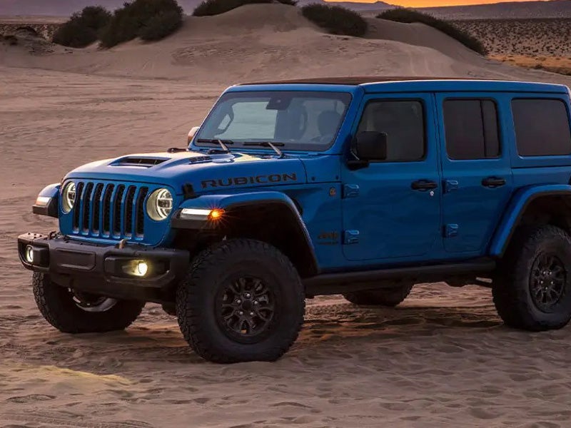 Dan Cummins Chrysler Dodge Jeep Ram Georgetown in Georgetown KY used Jeep Wrangler in blue parked at sunset